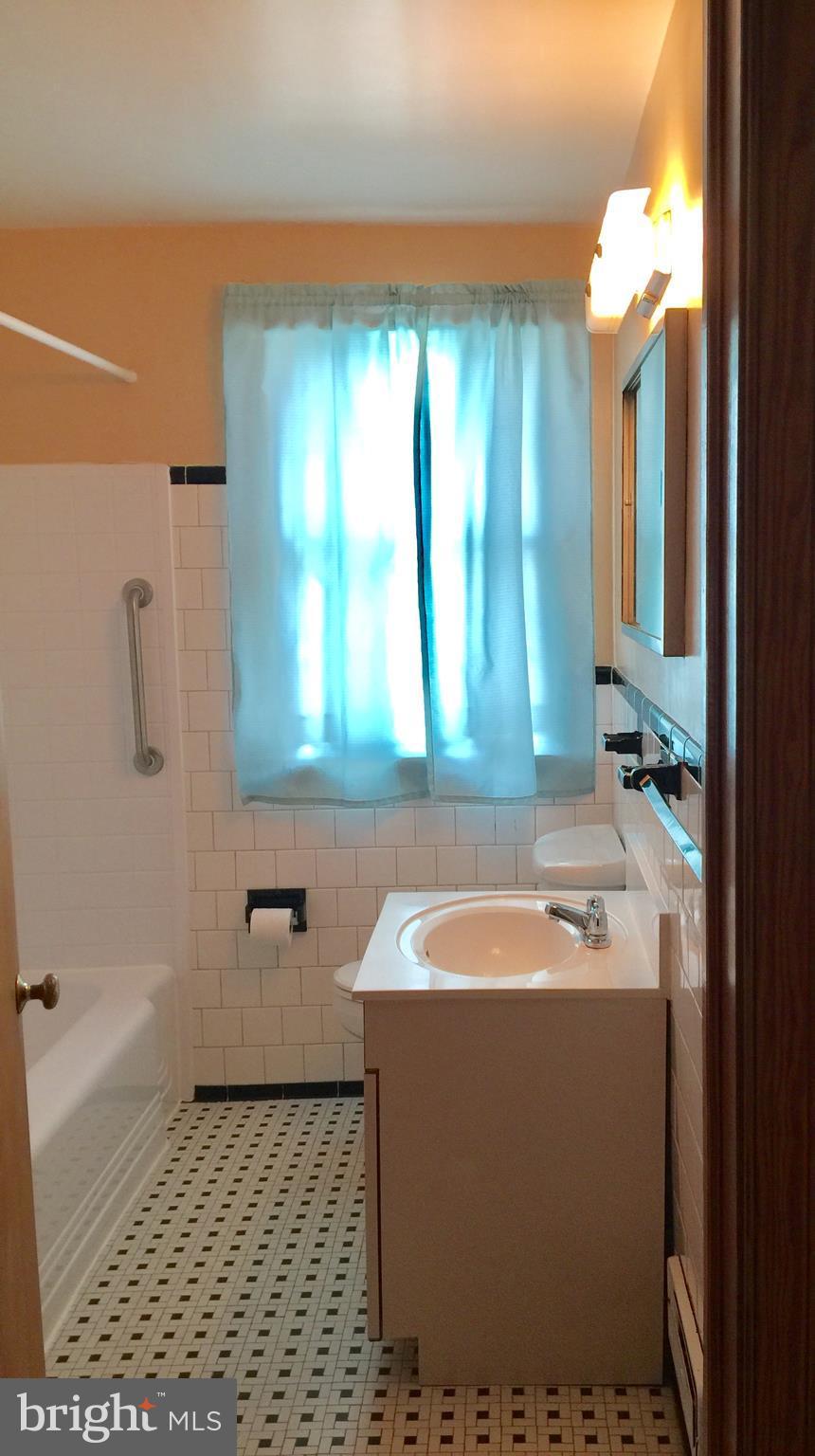 1807 Hanford Road Baltimore, MD 21237 - Photo 14 of 22 a bathroom with a tub a sink and a shower