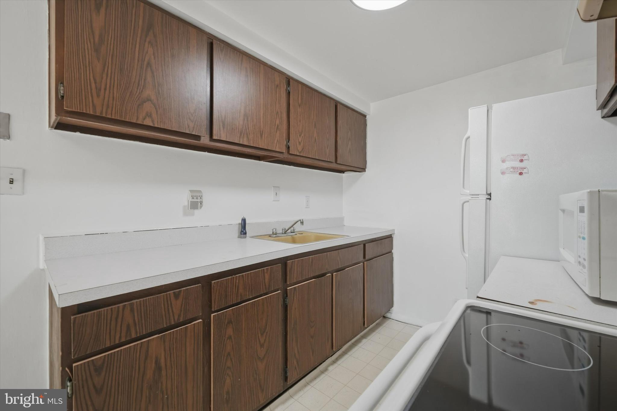 125 Elliot Street Newark, DE 19713 - Photo 14 of 32 a kitchen with a sink and cabinets