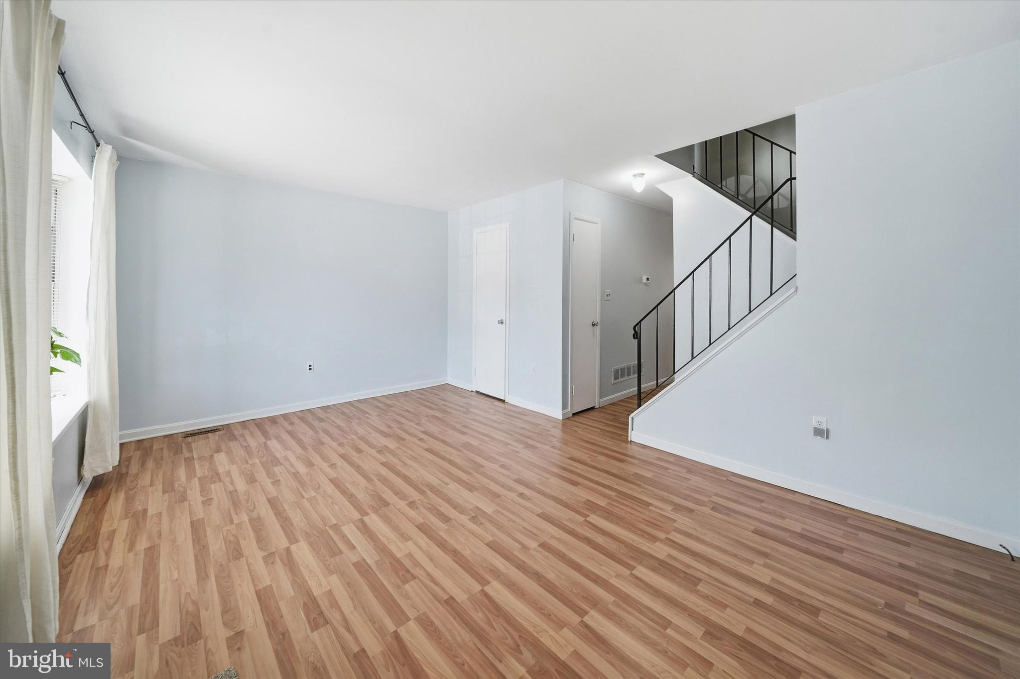 125 Elliot Street Newark, DE 19713 - Photo 4 of 32 a view of an empty room with wooden floor and stairs