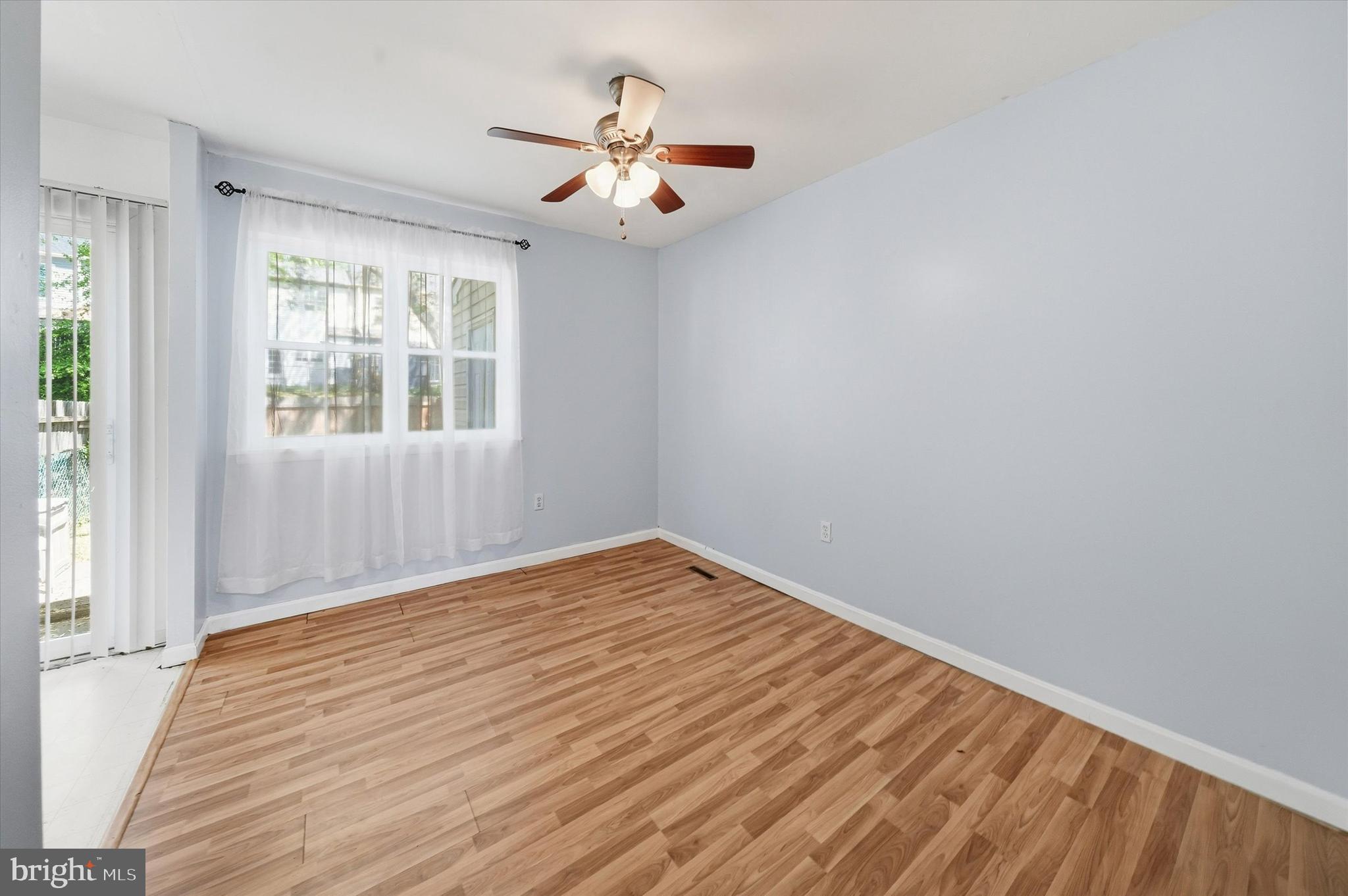 125 Elliot Street Newark, DE 19713 - Photo 8 of 32 wooden floor in an empty room with a window