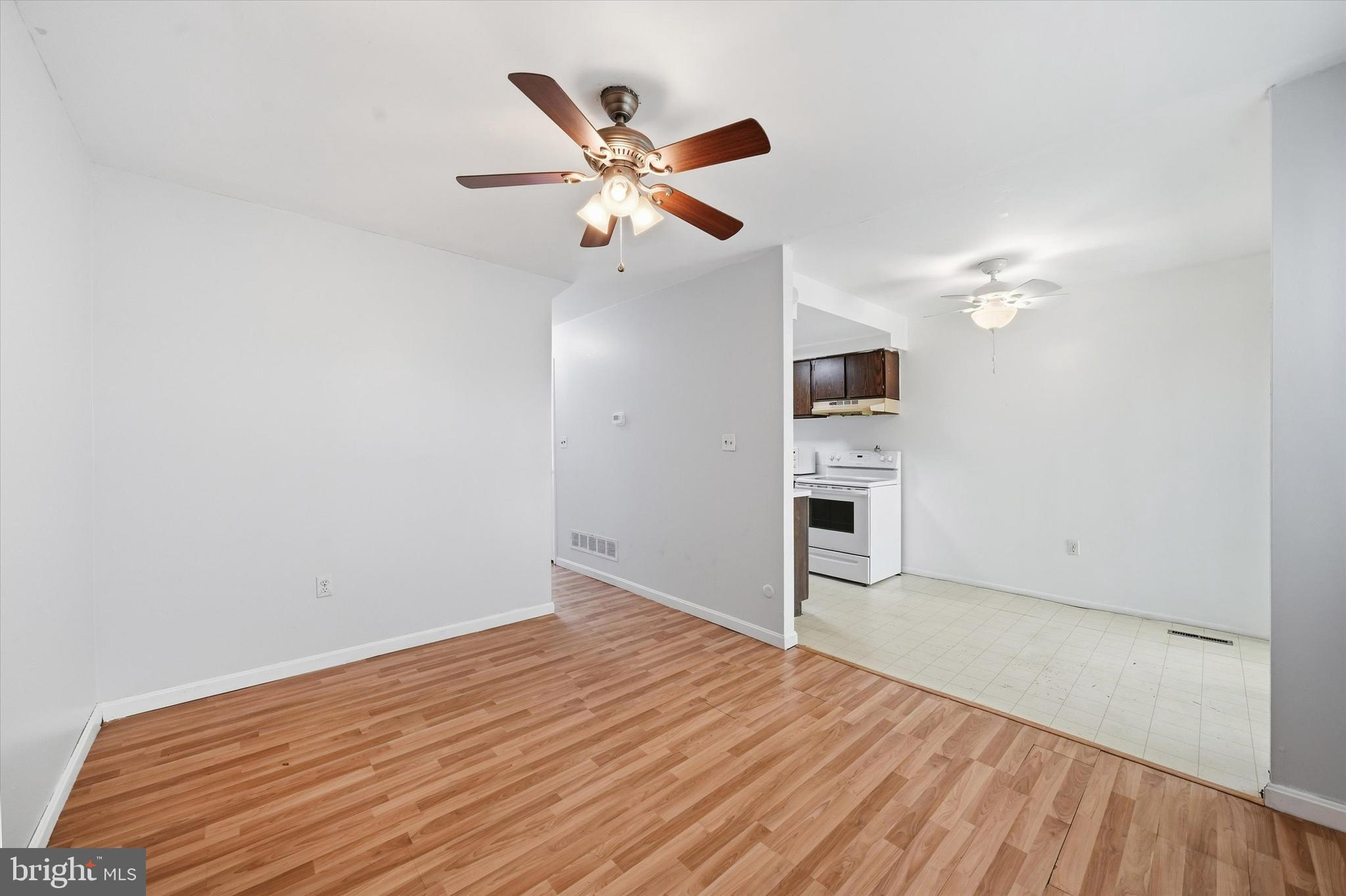 125 Elliot Street Newark, DE 19713 - Photo 9 of 32 a view of a livingroom with a ceiling fan and wooden floor