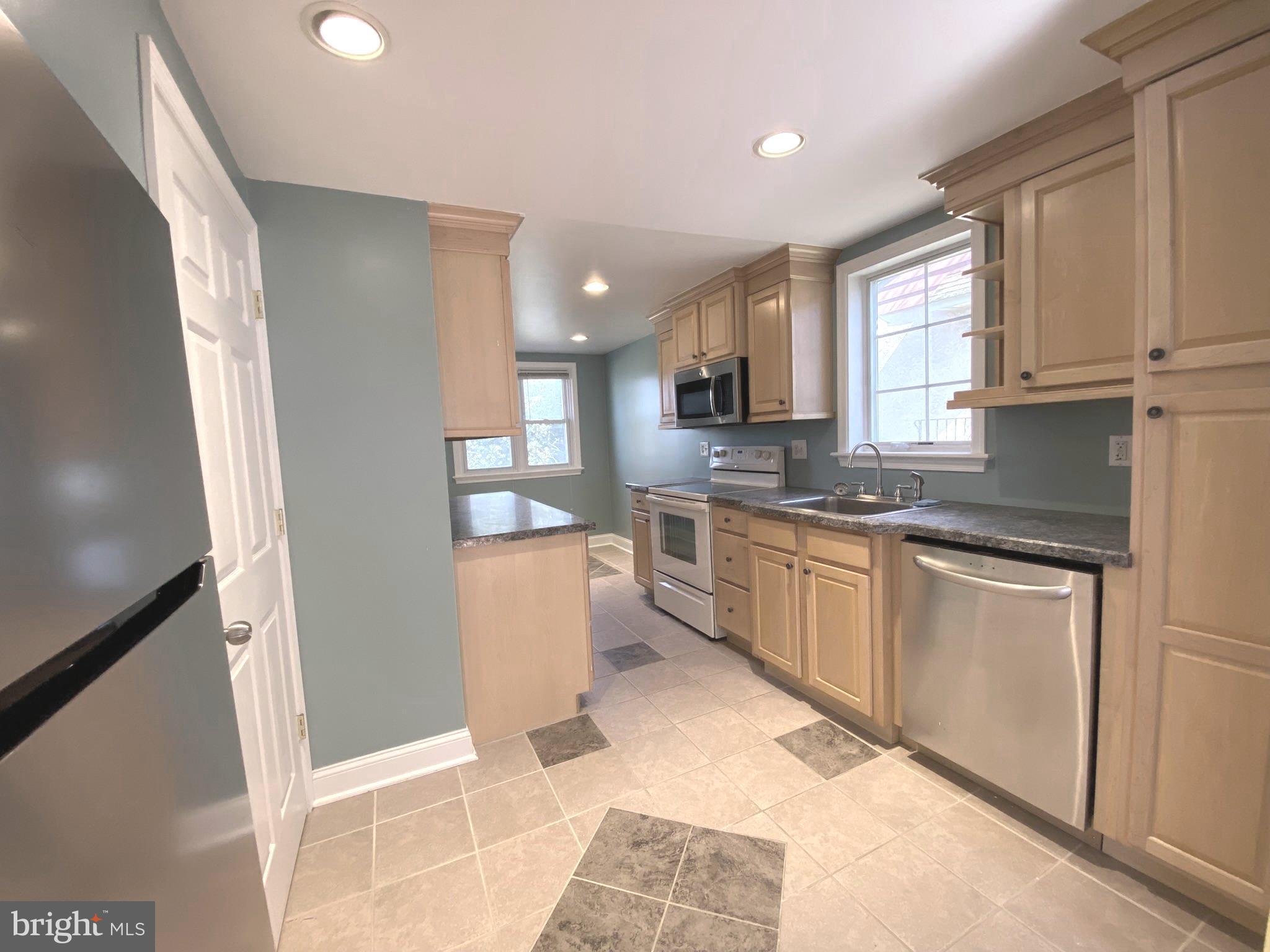 19 Woodhill Road Willow Grove, PA 19090 - Photo 6 of 24 a kitchen with stainless steel appliances granite countertop a refrigerator sink and white cabinets
