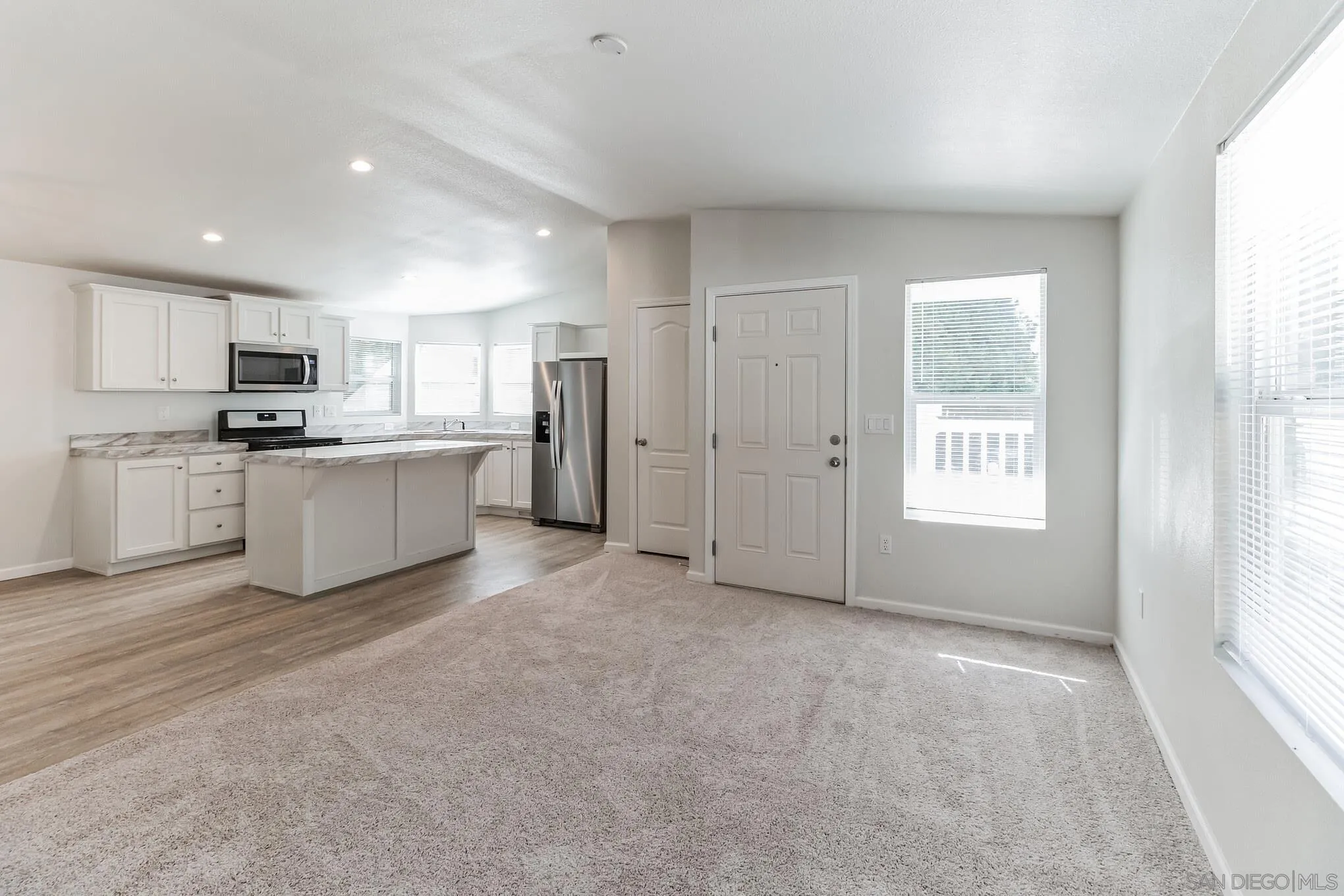 22899 Byron Road, Unit 35 Crestline, CA 92325 - Photo 17 of 18 a view of a kitchen with a sink stove cabinets and empty room