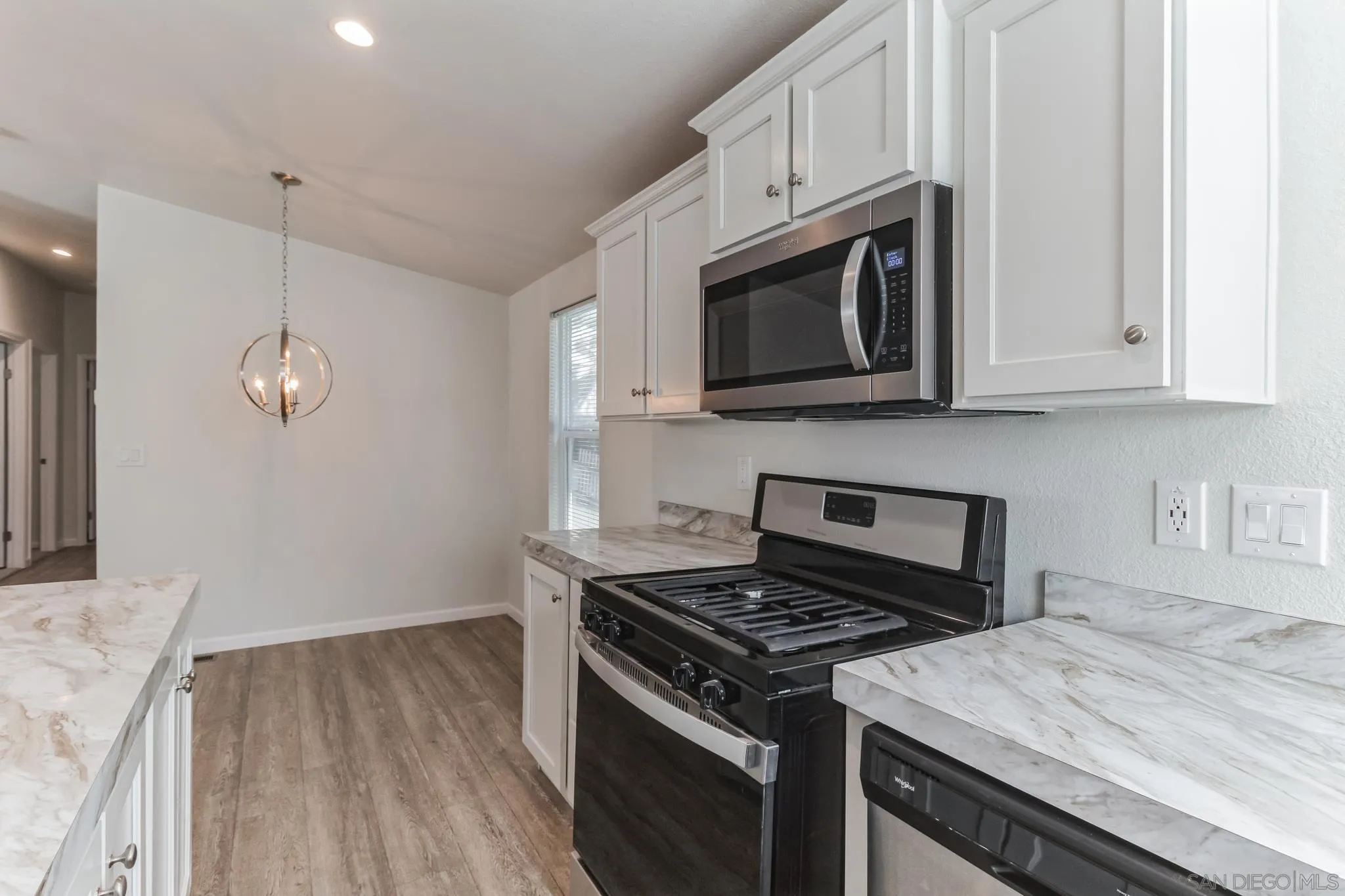 22899 Byron Road, Unit 35 Crestline, CA 92325 - Photo 7 of 18 a kitchen with granite countertop cabinets stainless steel appliances and wooden floor