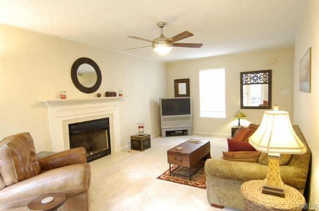 4513 Timberhurst Drive Raleigh, NC 27612 - Photo 2 of 10 a living room with furniture a window and a fireplace