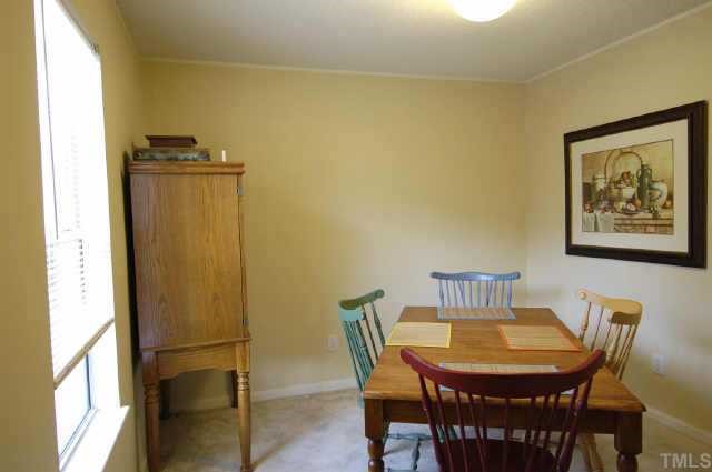 4513 Timberhurst Drive Raleigh, NC 27612 - Photo 3 of 10 a view of a dining room with furniture and a window