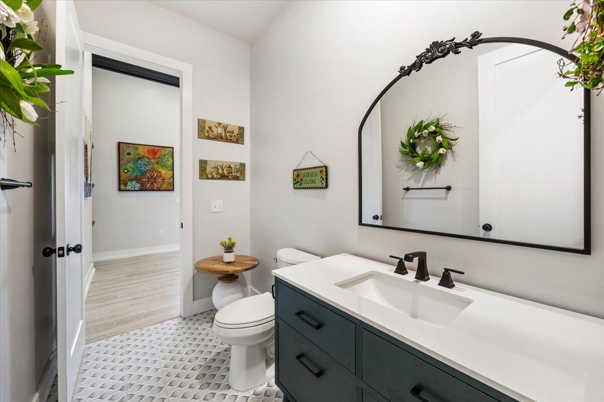 3574 Bob Tolbert Road Navarre, FL 32566 - Photo 23 of 67 a bathroom with a toilet a sink and mirror