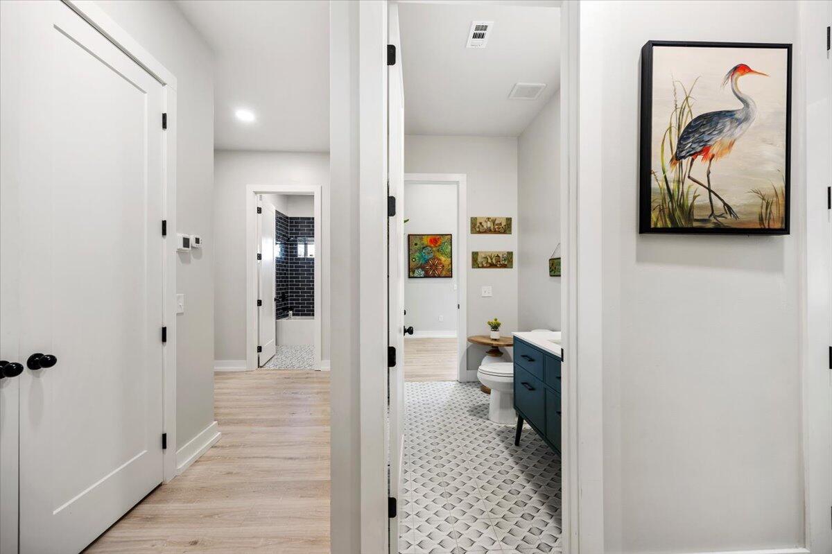 3574 Bob Tolbert Road Navarre, FL 32566 - Photo 25 of 67 a bathroom with a painting on the wall and a shower
