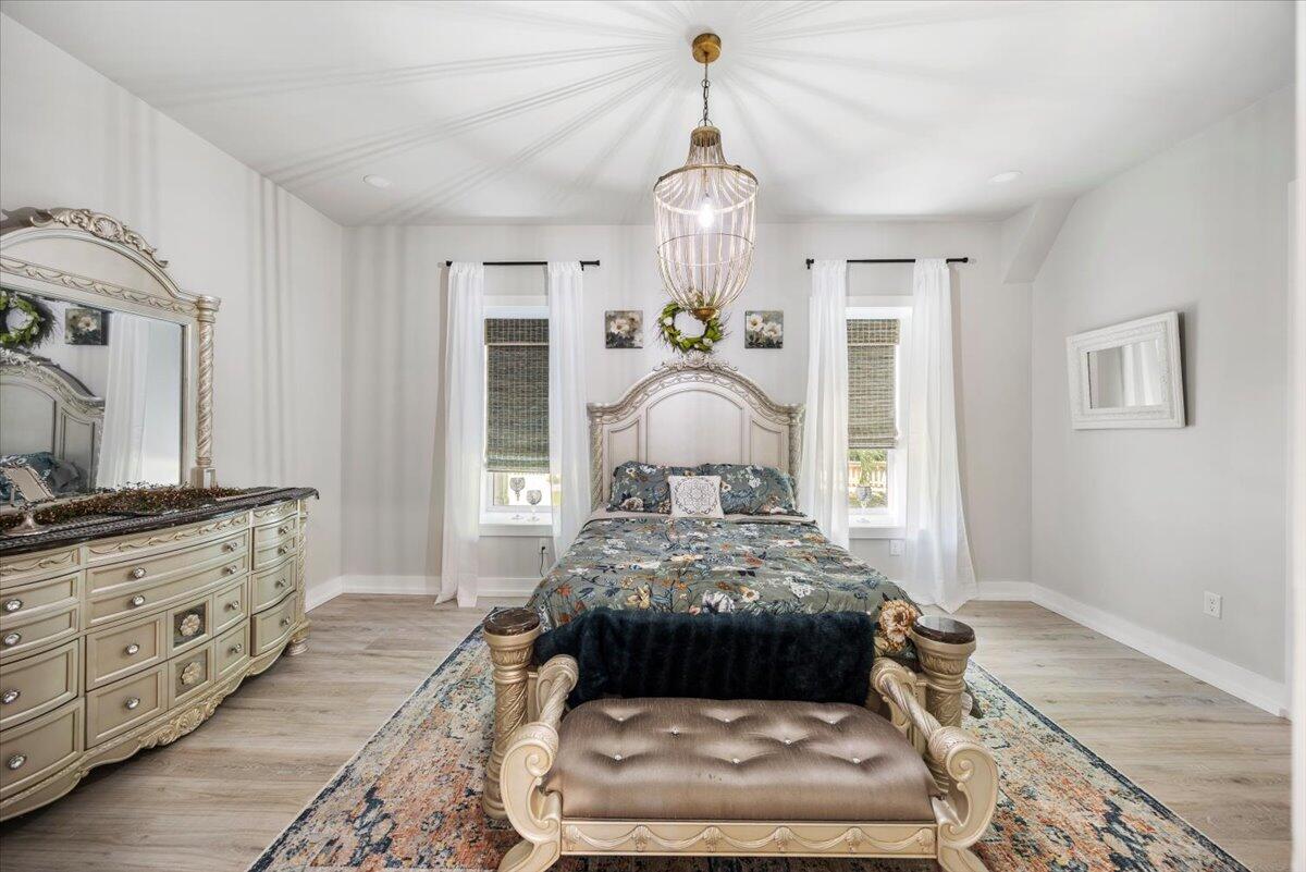 3574 Bob Tolbert Road Navarre, FL 32566 - Photo 28 of 67 a bedroom with a large bed and a dresser