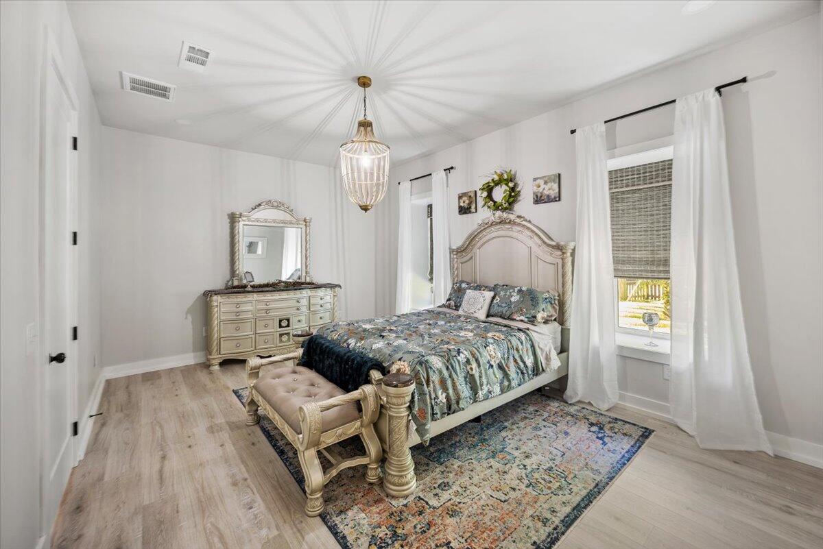 3574 Bob Tolbert Road Navarre, FL 32566 - Photo 30 of 67 a bedroom with bed and window