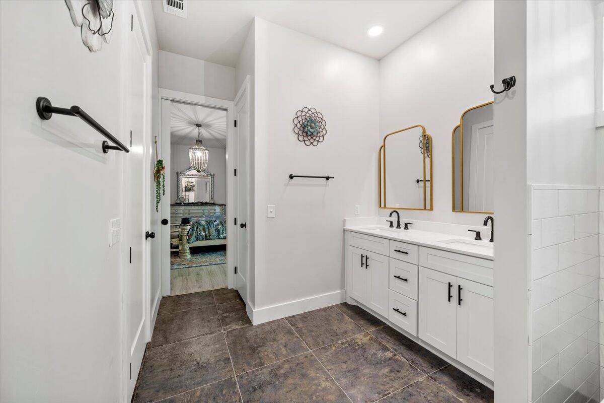 3574 Bob Tolbert Road Navarre, FL 32566 - Photo 32 of 67 a bathroom with a double vanity sink mirror and shower