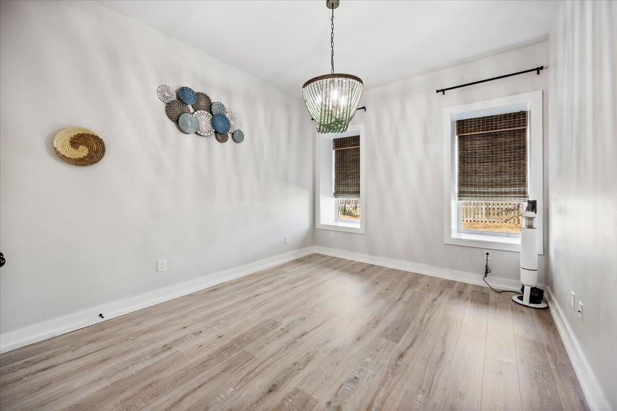 3574 Bob Tolbert Road Navarre, FL 32566 - Photo 38 of 67 wooden floor in an empty room with a window