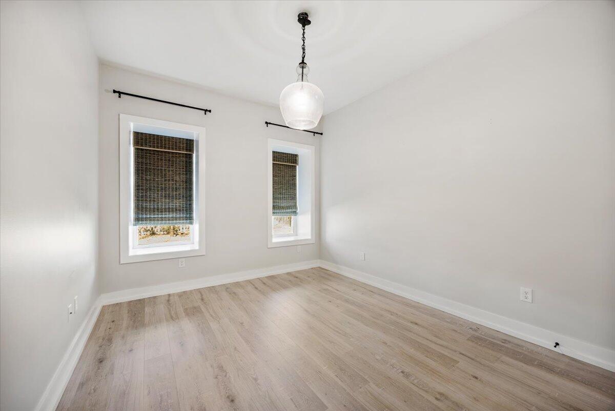 3574 Bob Tolbert Road Navarre, FL 32566 - Photo 40 of 67 a view of an empty room with wooden floor and windows
