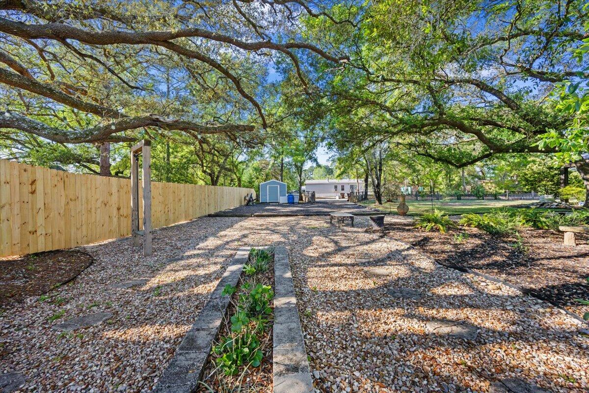 3574 Bob Tolbert Road Navarre, FL 32566 - Photo 50 of 67 a backyard of a house with lots of green space