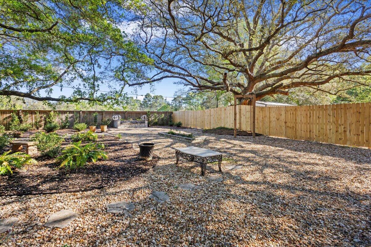 3574 Bob Tolbert Road Navarre, FL 32566 - Photo 51 of 67 a view of a bench in a backyard
