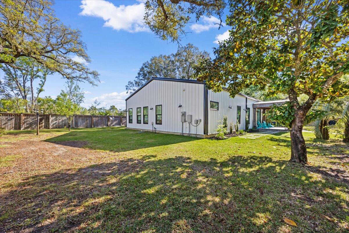 3574 Bob Tolbert Road Navarre, FL 32566 - Photo 61 of 67 a view of an house with backyard and trees