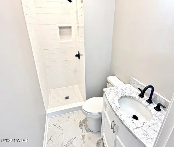 a bathroom with a sink toilet and shower