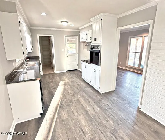 a view of a kitchen with wooden floor