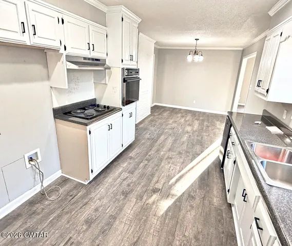 a kitchen with stainless steel appliances granite countertop a stove and a sink