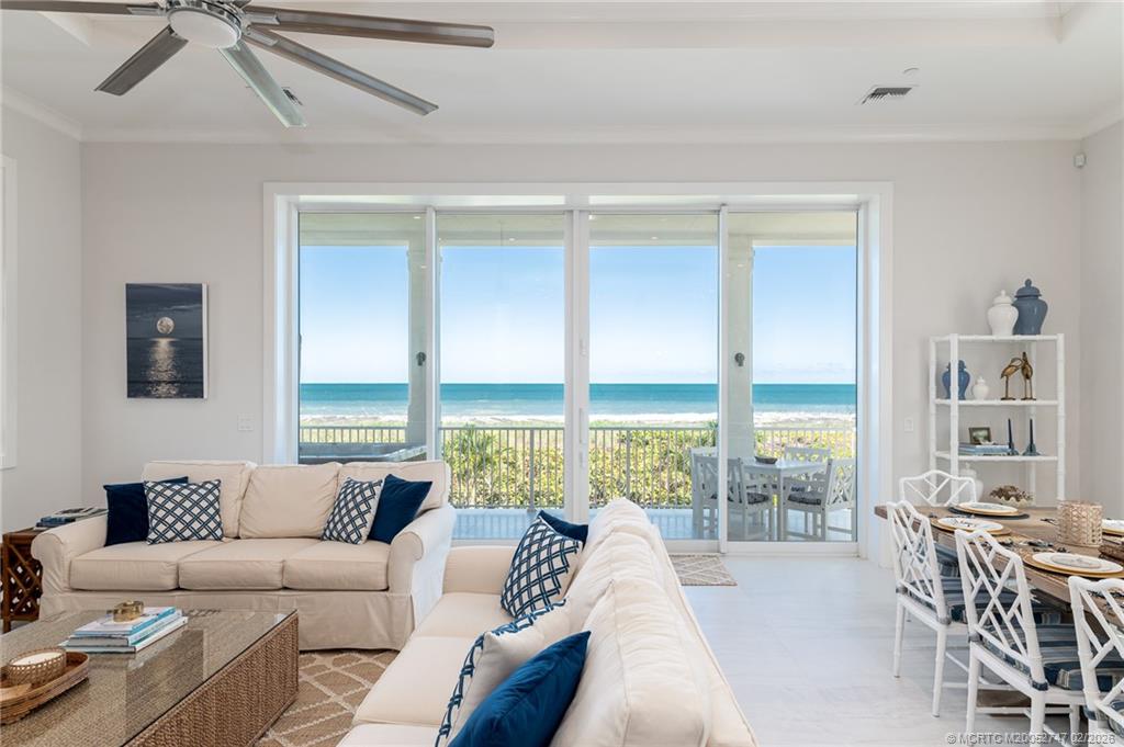 4824 Watersong Way Fort Pierce, FL 34949 - Photo 14 of 65 a living room with furniture and large windows