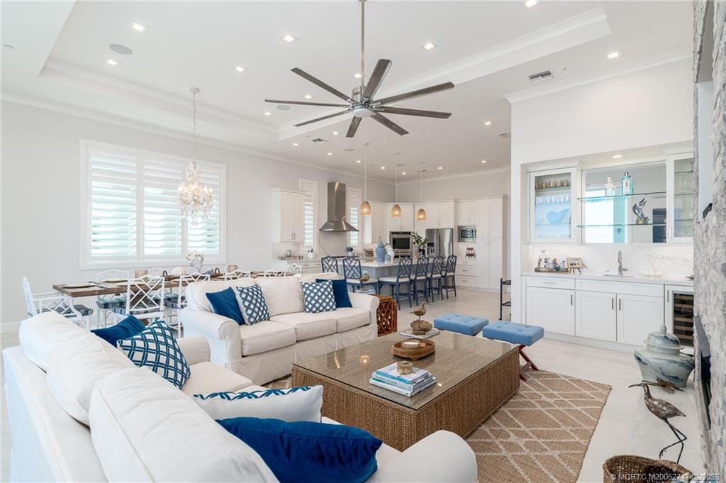 4824 Watersong Way Fort Pierce, FL 34949 - Photo 16 of 65 a living room with furniture kitchen view and a large window