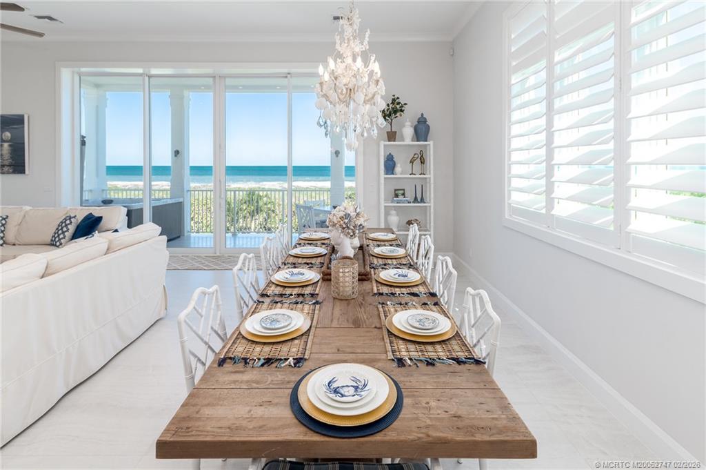 4824 Watersong Way Fort Pierce, FL 34949 - Photo 22 of 65 a view of a dining room and hall with furniture