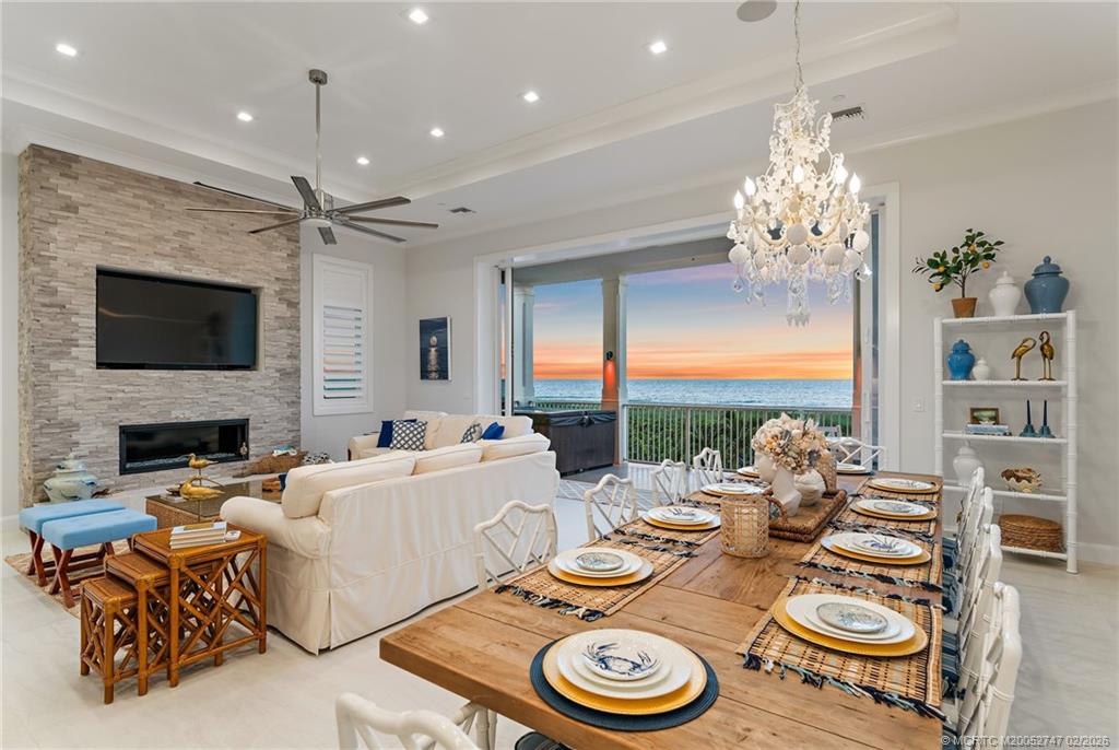 4824 Watersong Way Fort Pierce, FL 34949 - Photo 24 of 65 a view of a dining room with furniture a chandelier and large window