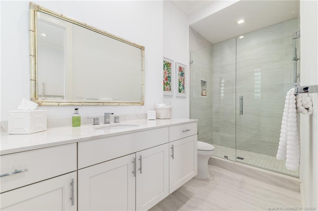 4824 Watersong Way Fort Pierce, FL 34949 - Photo 31 of 65 a bathroom with a shower sink and mirror