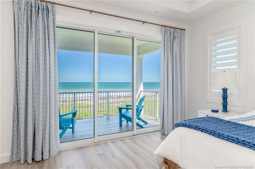 4824 Watersong Way Fort Pierce, FL 34949 - Photo 35 of 65 a bedroom with a balcony and large window