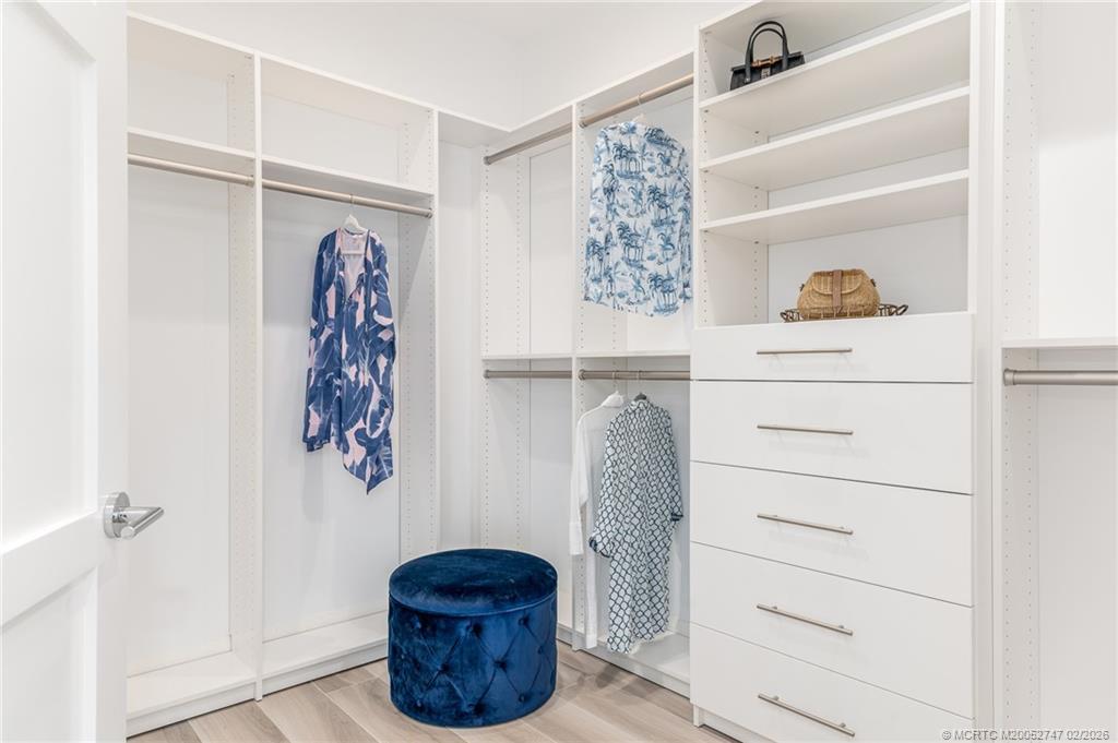 4824 Watersong Way Fort Pierce, FL 34949 - Photo 37 of 65 a view of walk in closet with clothes and shoes