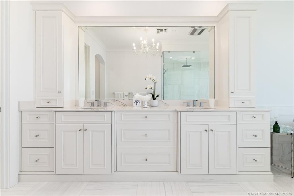 4824 Watersong Way Fort Pierce, FL 34949 - Photo 40 of 65 a bathroom with a sink and a mirror