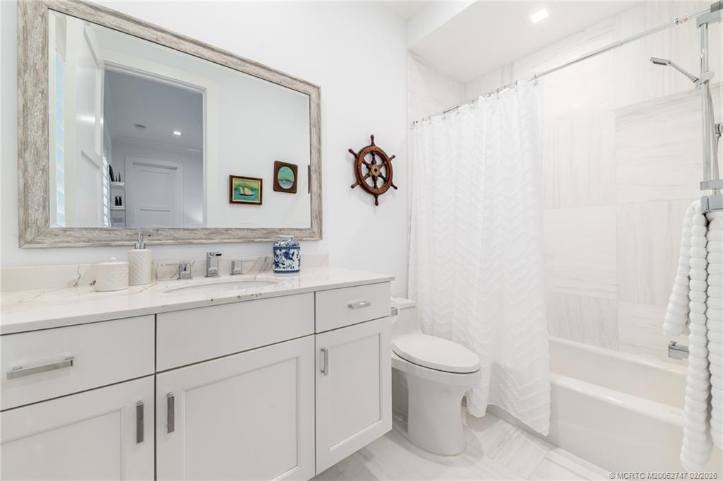 4824 Watersong Way Fort Pierce, FL 34949 - Photo 42 of 65 a bathroom with a sink a toilet and a mirror