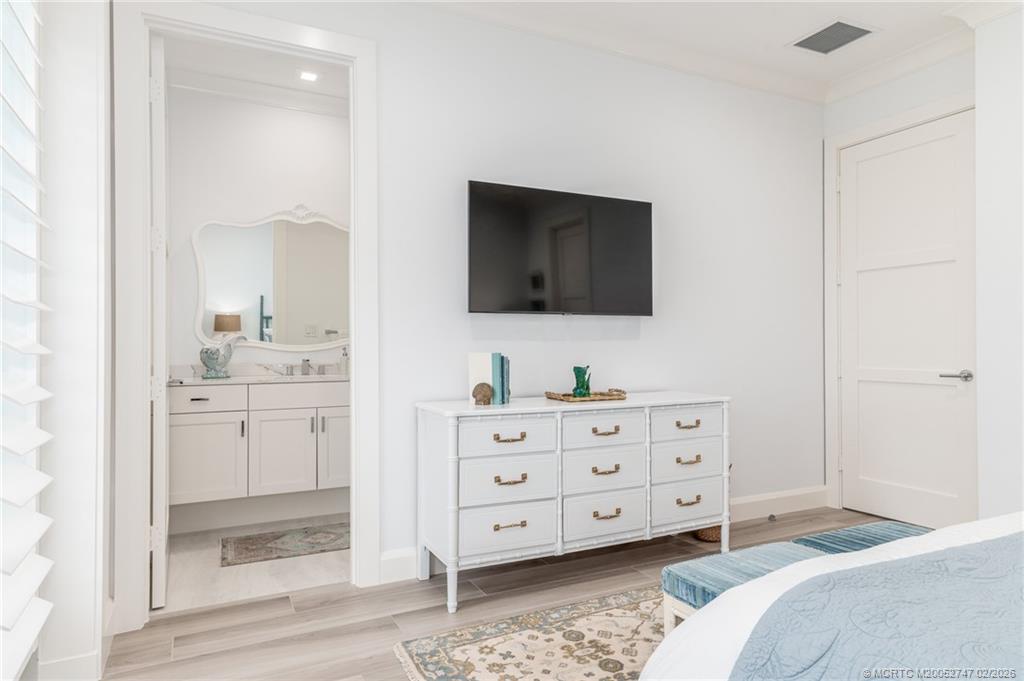 4824 Watersong Way Fort Pierce, FL 34949 - Photo 44 of 65 a bedroom with a bed and a flat tv screen in it