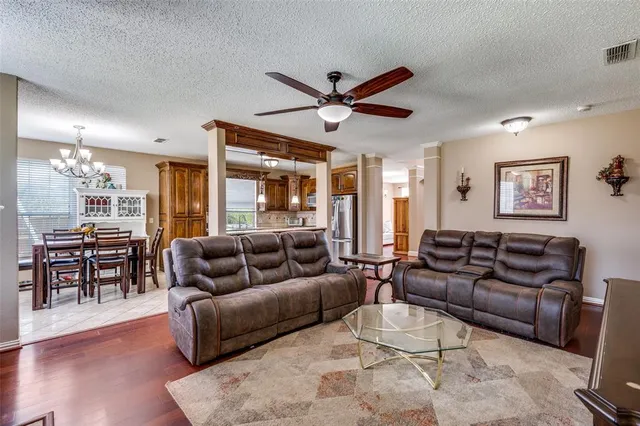 a living room with furniture ceiling fan and a window