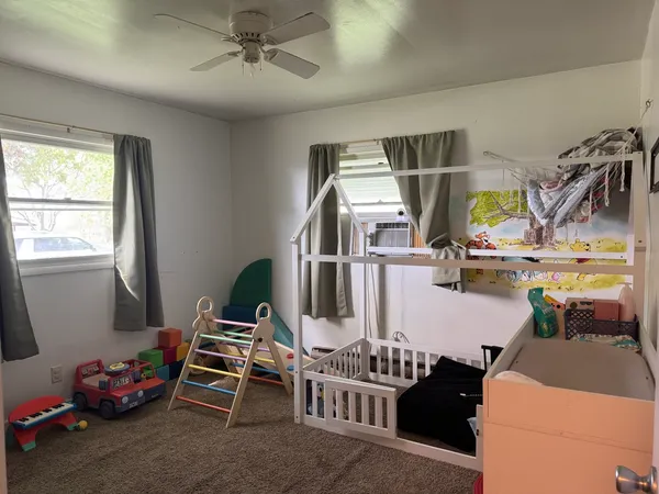 a bedroom with furniture and a window
