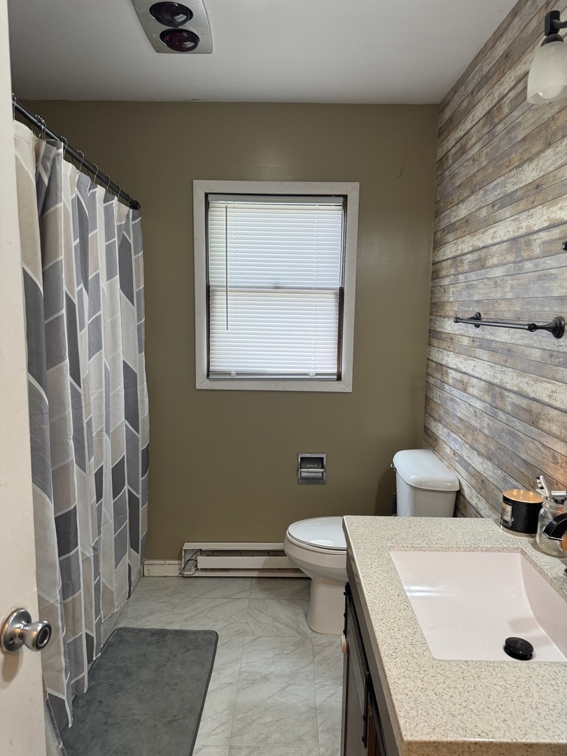 419 East Cleveland Street Cullom, IL 60929 - Photo 12 of 14 a bathroom with a sink toilet and shower
