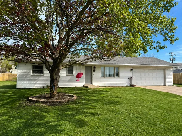 a front view of house with yard and trees