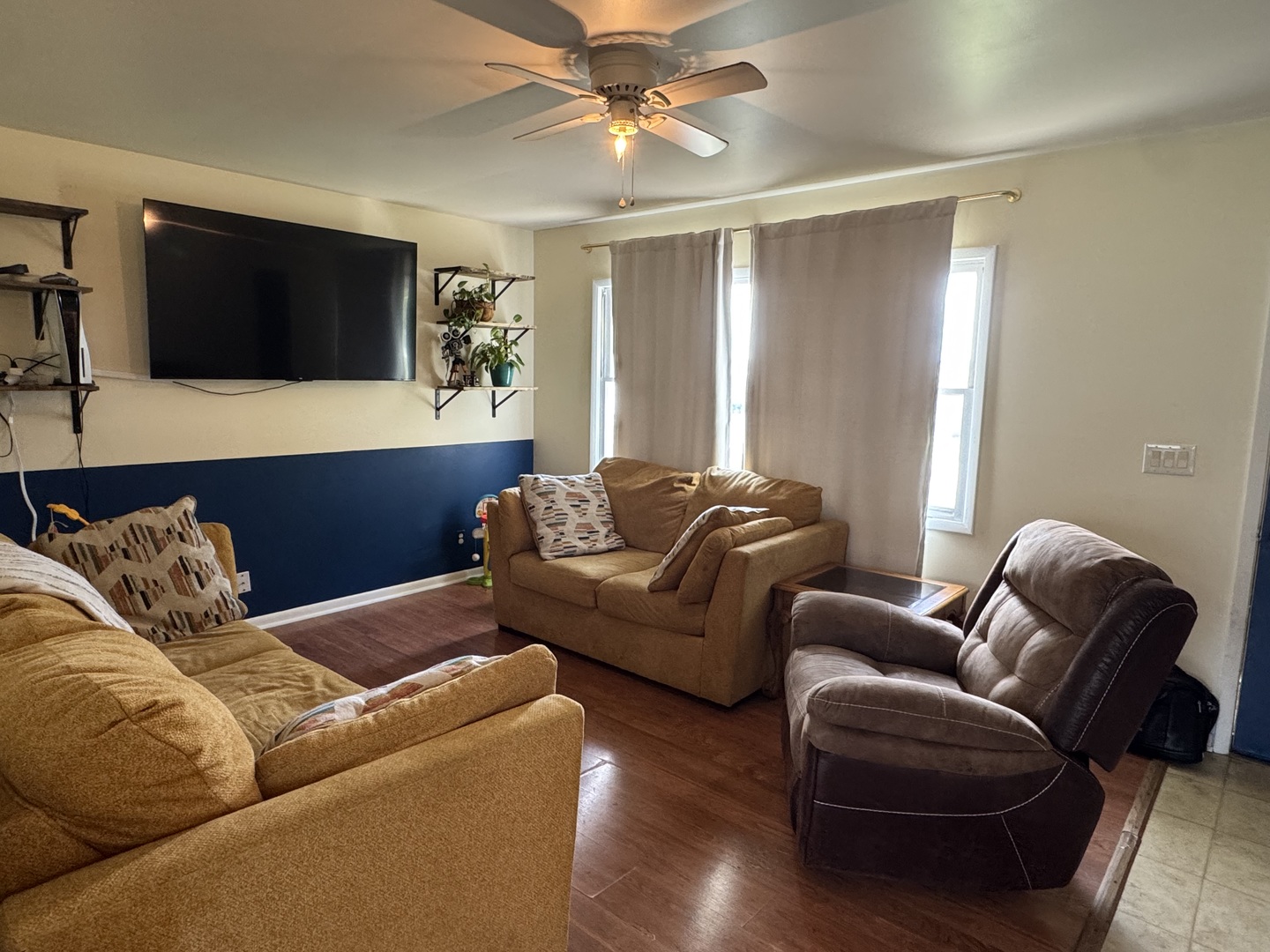 419 East Cleveland Street Cullom, IL 60929 - Photo 6 of 14 a living room with furniture ceiling fan and a flat screen tv