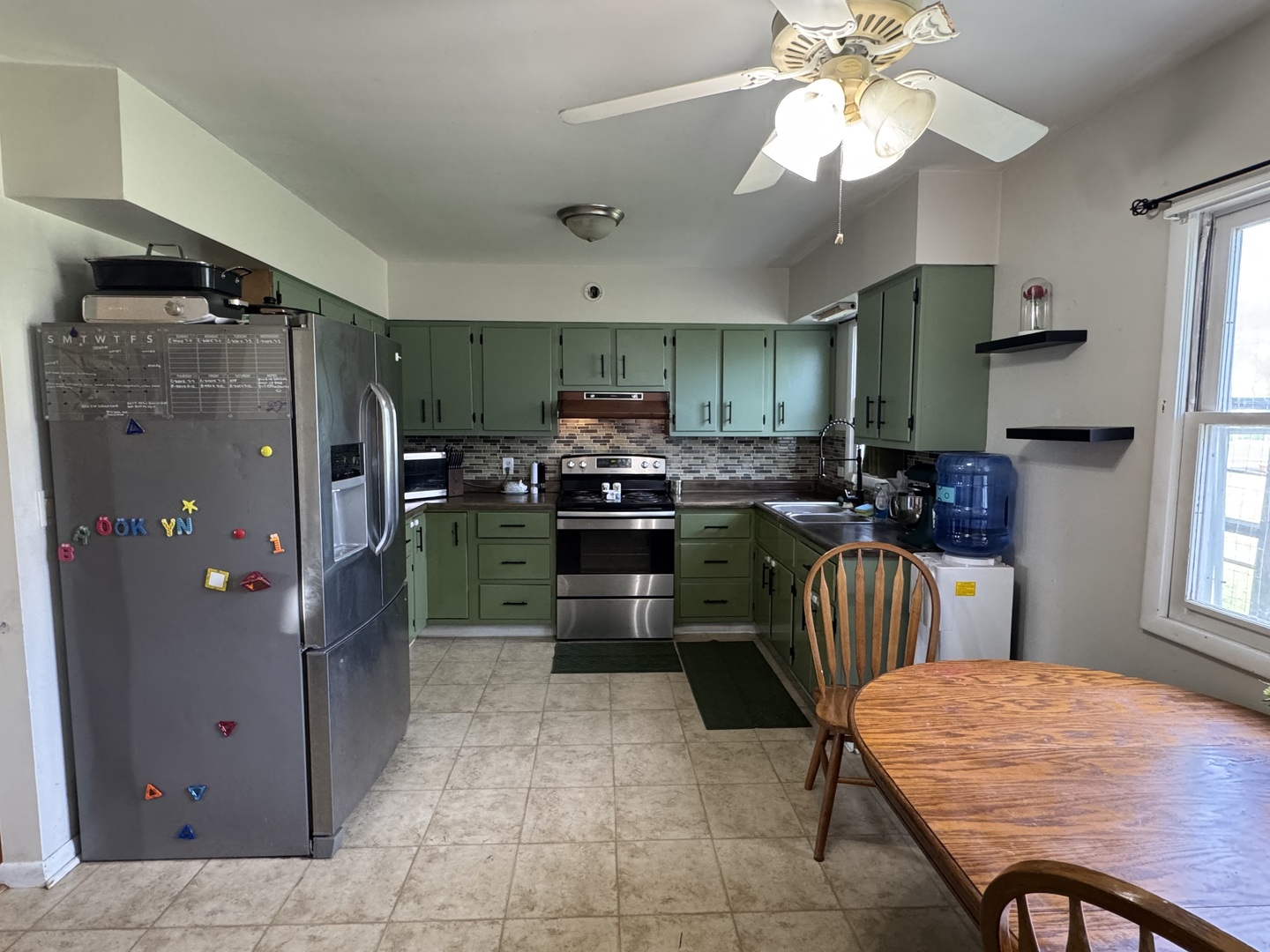 419 East Cleveland Street Cullom, IL 60929 - Photo 7 of 14 a kitchen with stainless steel appliances granite countertop a refrigerator and a stove top oven