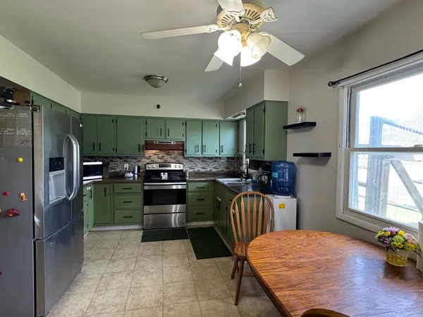 a kitchen with a refrigerator and a stove