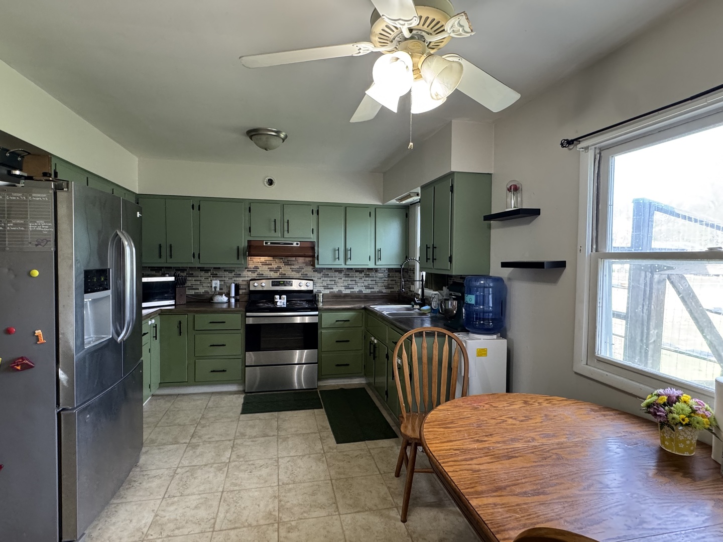 419 East Cleveland Street Cullom, IL 60929 - Photo 8 of 14 a kitchen with a refrigerator and a stove