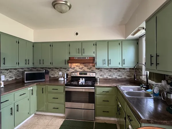 a kitchen with a stove and a sink