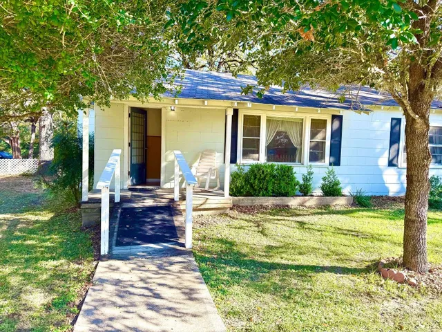 a view of a house with backyard porch and sitting area