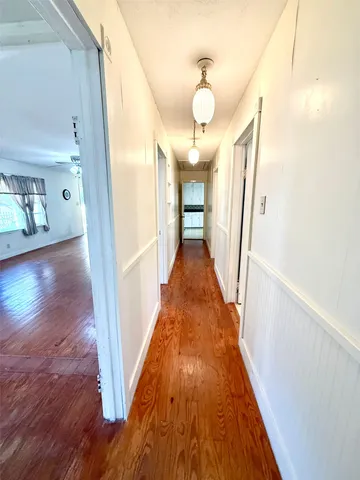 a view of a hallway view with wooden floor