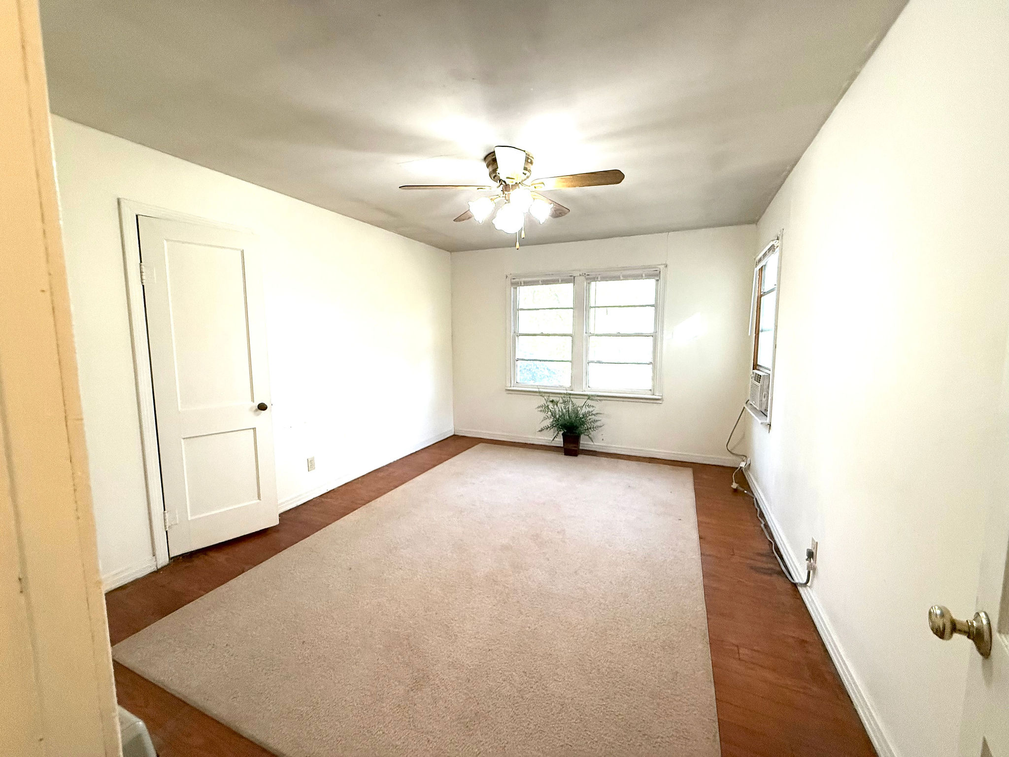 9278 Highway 77 Lexington, TX 78947 - Photo 21 of 37 an empty room with windows and chandelier fan