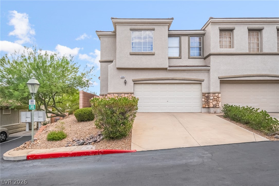 224 Positive Point Street Henderson, NV 89012 - Photo 1 of 44 A stucco exterior with stone accents frames the two-car garage of this multi-level home.