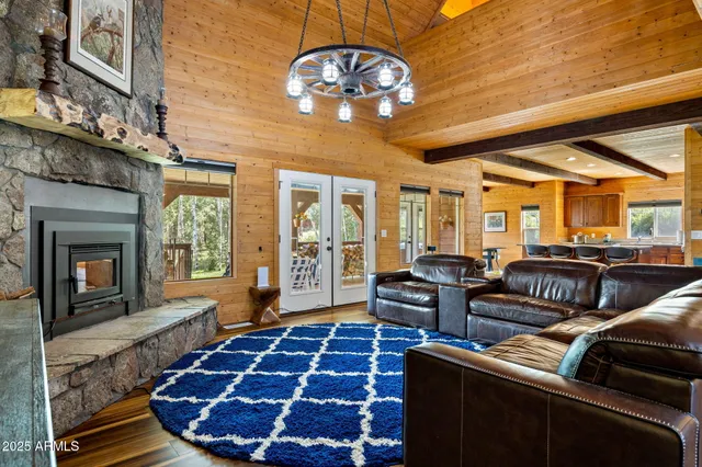 a view of a couches with wooden floor and fence