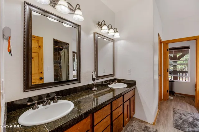 a view of a house with a small yard and wooden fence