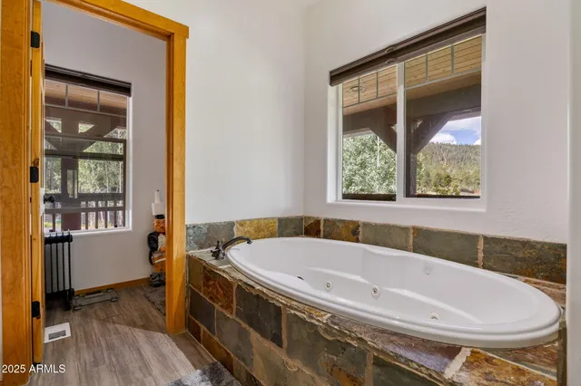 a view of a house with a small yard and a large tree