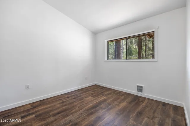 a view of a houses with a lush green hillside